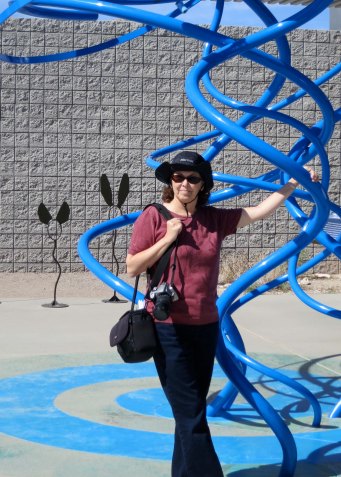 Peggy is standing next to a sculpture resenting air.