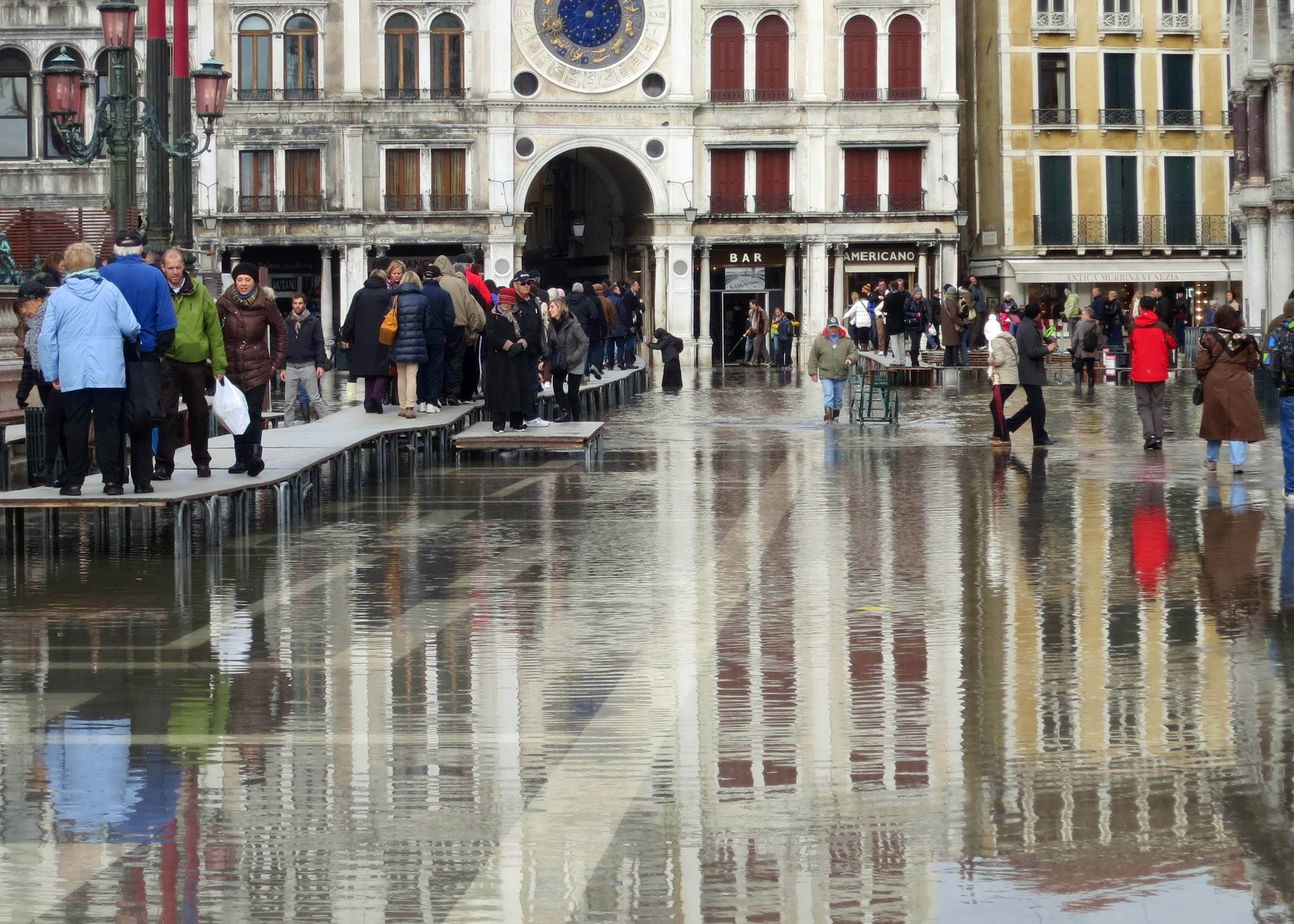 As I mentioned, Venice is subject to frequent floods. Global warming has added to this problem. This shot, taken just below the Clock Tower in St. Mark's Square, shows people using the table walkways and walking through the water.