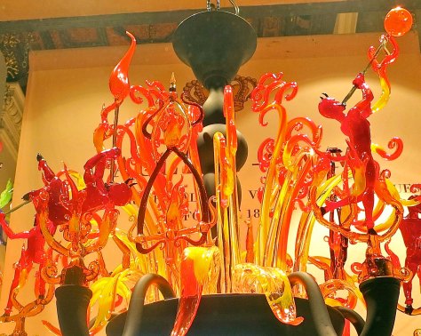 I suspect the artist who created this sculpture of glass blowers had devilish fun with his work.