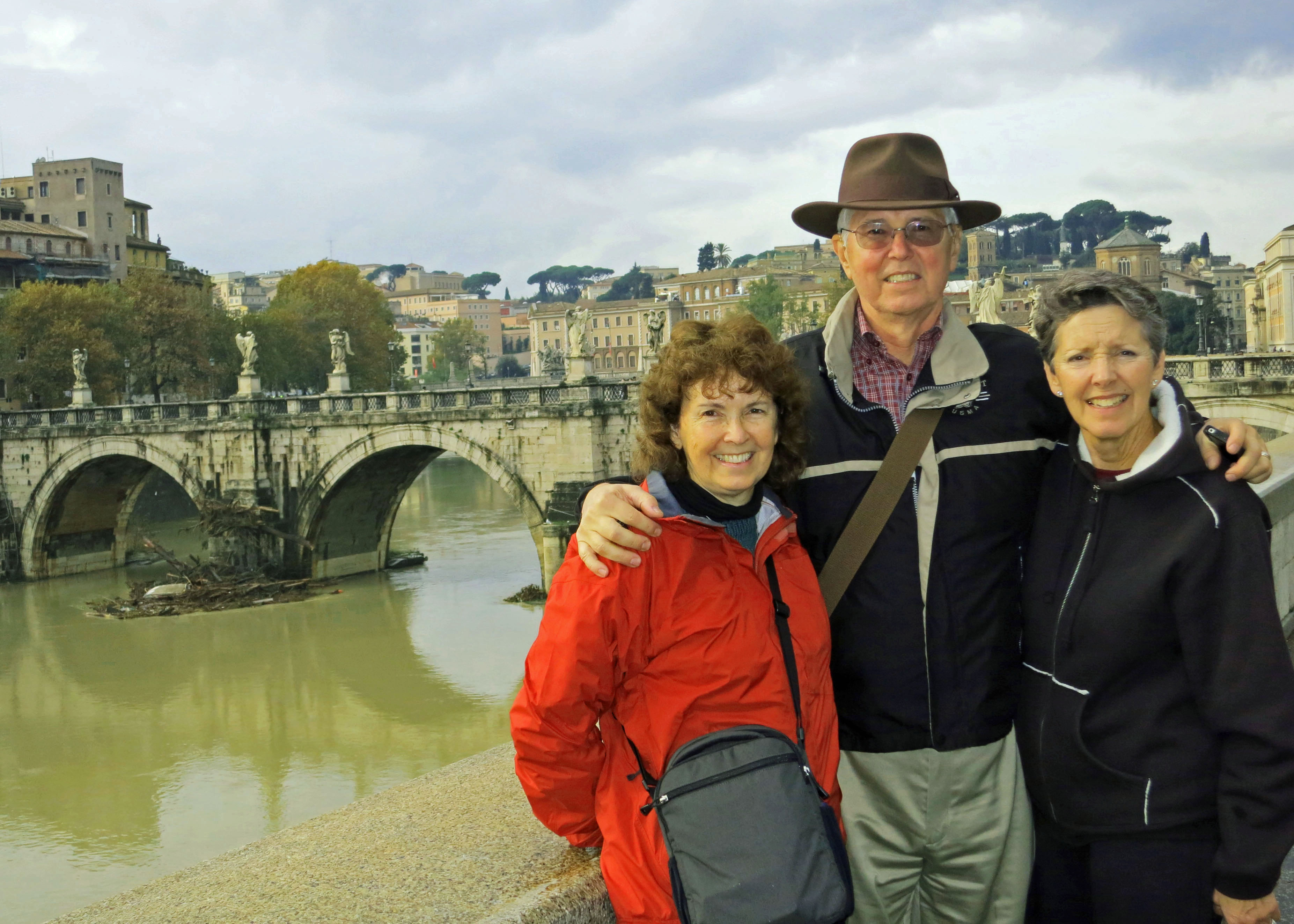 Peggy, her brother John and his wife Frances stand in front of the Tiber River and the Pont St. Angelo (the Bridge of Angels)