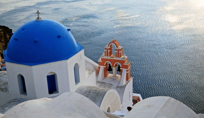 The Anastasis Church in Oia provides a striking view of the Aegean Sea.