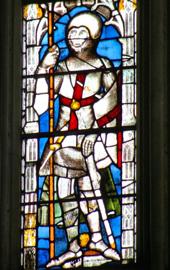 An early stained glass window featuring a knight.