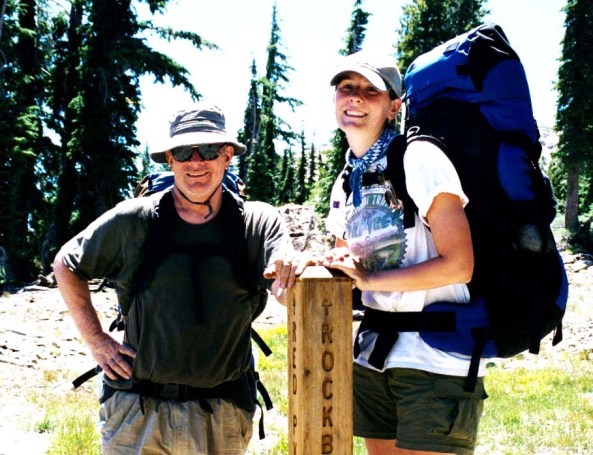 Speaking of family, this is our daughter Tasha standing with me in the Desolation Wilderness next to a trail sign. She went on several treks with us.